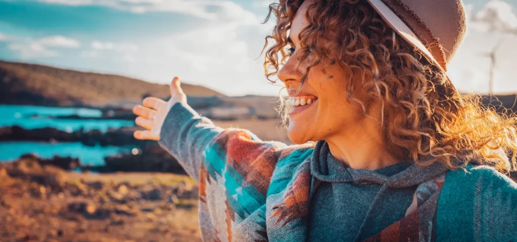 woman enjoying coastal scenery with arms outstretc utc